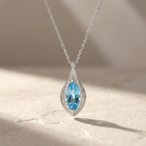 Close up of marquise cut blue topaz gemstone in sterling silver pendant