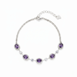 Silver-colored February birthstone bracelet on a white background, featuring five oval amethysts with clear halos, a Cuban chain, lobster clasp, and extension.