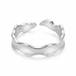 Silver-colored wave open ring on a white background, showing the broad reflective band, undulating upper and lower edges, and separated ends at the back.