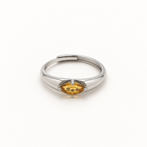 Front view of a marquise citrine ring on a cream-white background, showing the horizontal golden-yellow gemstone, four-prong setting, and overlapping silver-colored band.