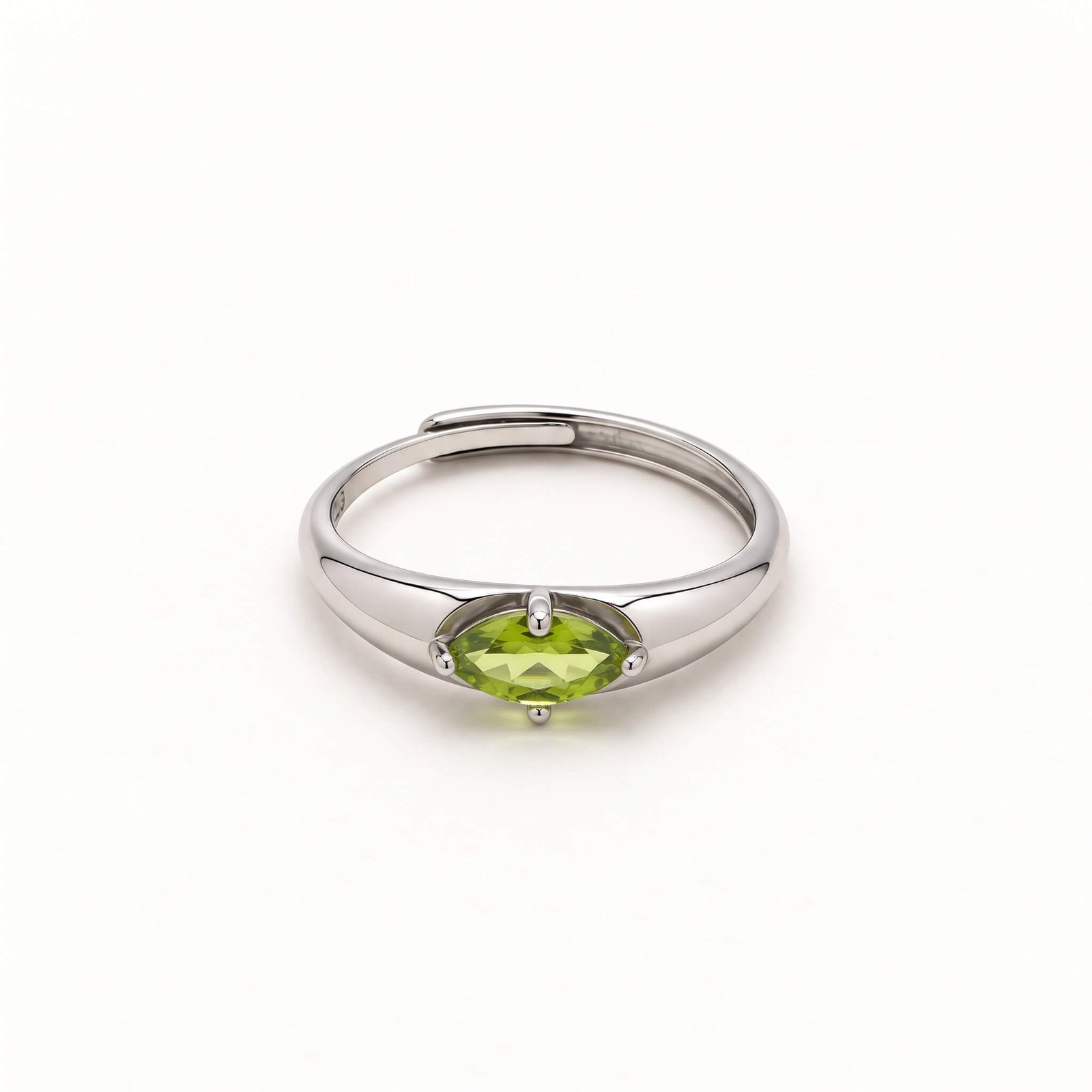 Front view of a marquise peridot ring on a white background, showing the horizontal yellow-green gemstone, four-prong setting, and overlapping silver-colored band.