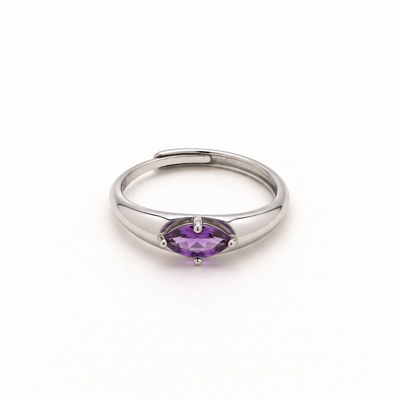 Front view of a marquise amethyst ring on a white background, showing the horizontal purple gemstone, four-prong setting, and overlapping silver-colored band.